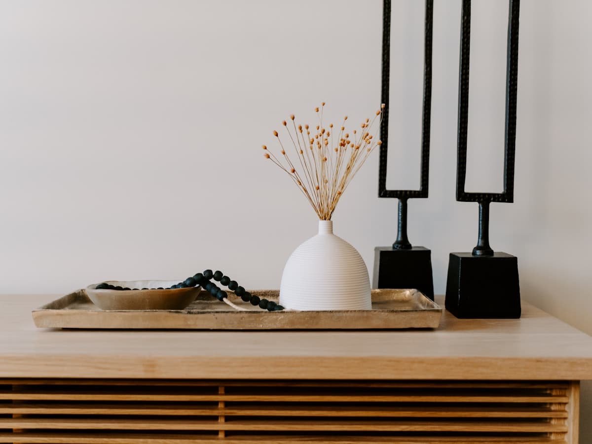 Vase with dried stems on a wooden console