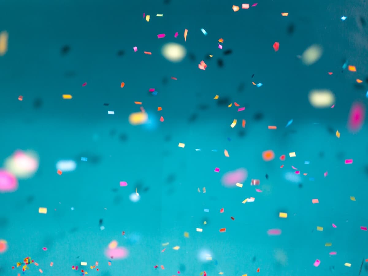 Confetti falling against a teal background